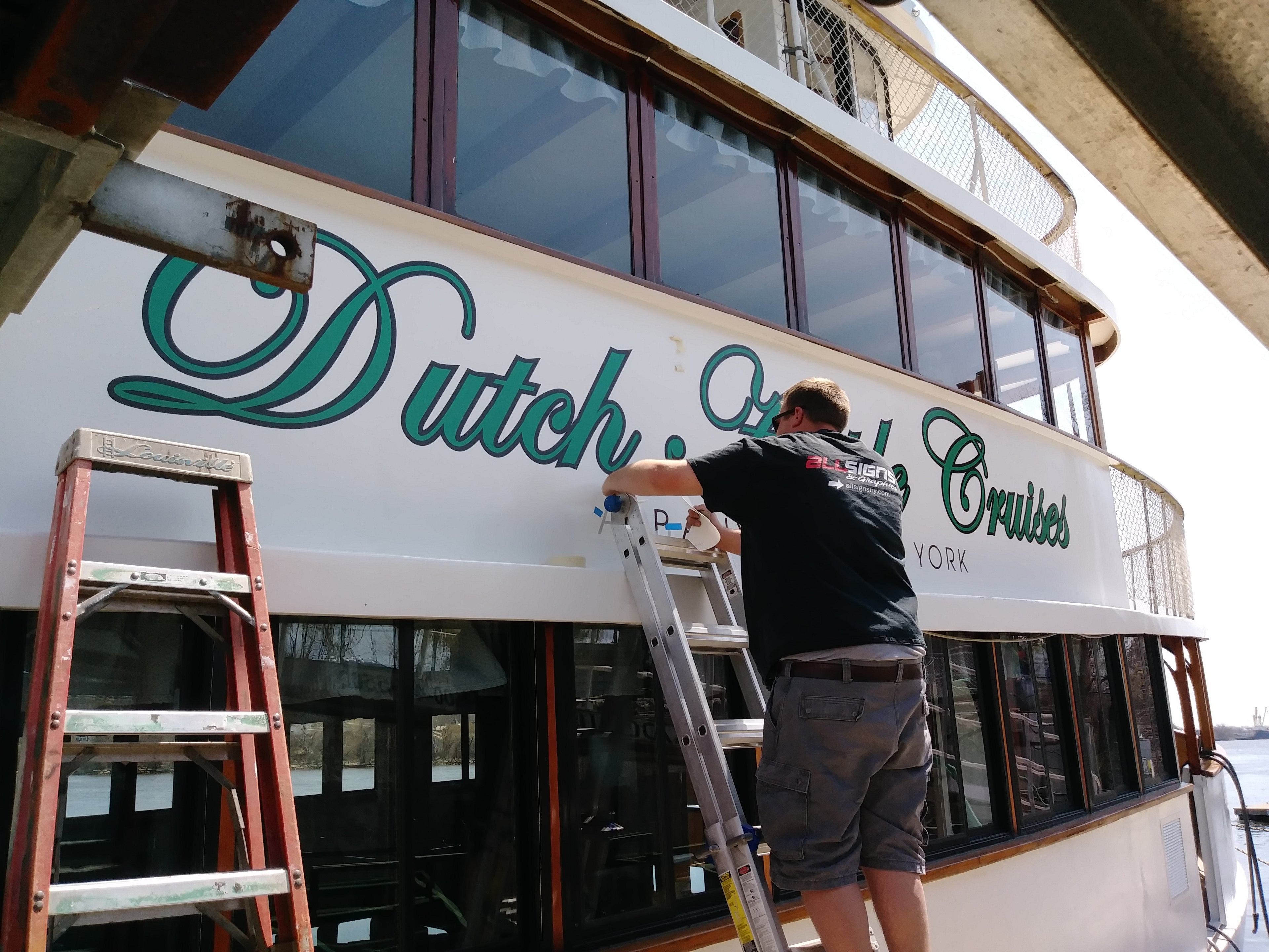 High performance, digitally printed and laminated cast vinyl lettering installed on large boat. Boat name and port of call installed on ship by expert vinyl graphics manufacturers and installers, All Signs & Graphics Inc.