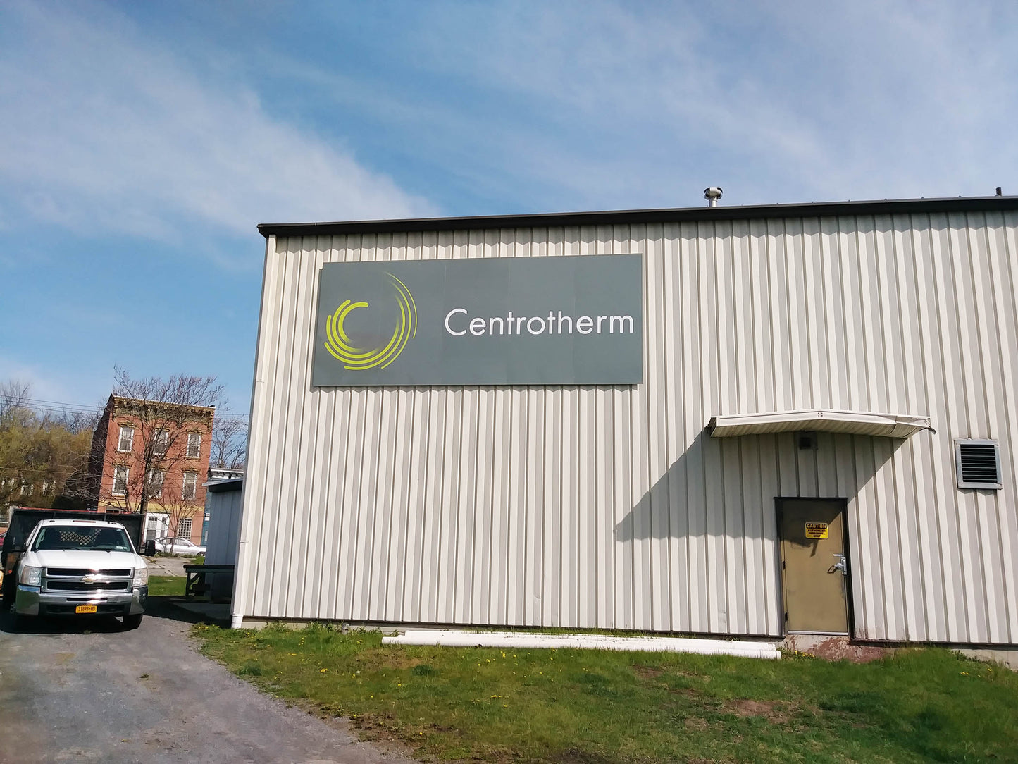 Large aluminum composite building sign panels. Dibond logo sign panels installed on metal building.