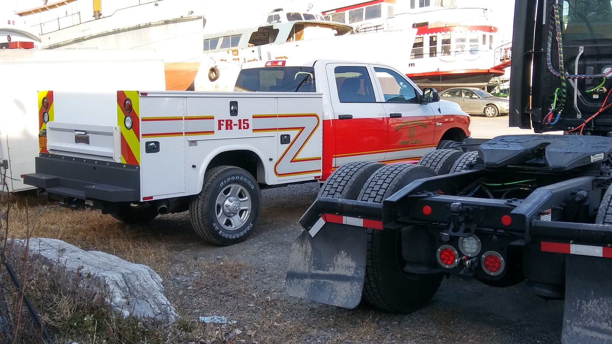 Fire truck lettering installed on utility truck by All Signs & Graphics Inc.  Red vinyl wrap on cab of truck with reflective stripe and gold leaf vinyl lettering installed on the doors.  Safety fluorescent yellow and red prismatic reflective vinyl chevrons installed on rear as well as truck unit numbers.