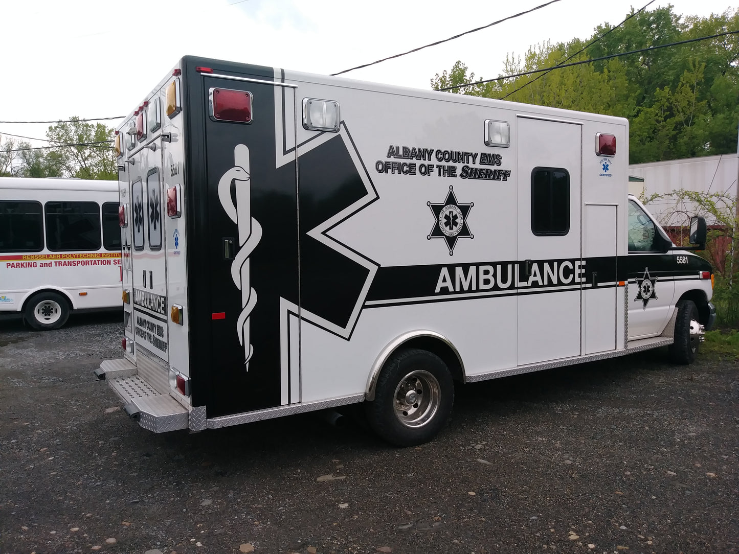 EMS ambulance vinyl graphics kit produces and installed by All Signs & Graphics Inc.  The design features a vinyl wrap with reflective vinyl graphics and lettering installed, as well as printed perforated view through vinyl  graphics installed on rear windows.