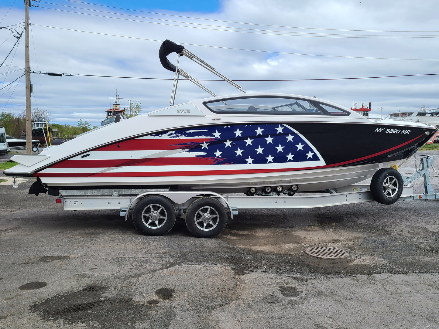Boat hull wrap installed on power boat. American flag wrap installed on boat.