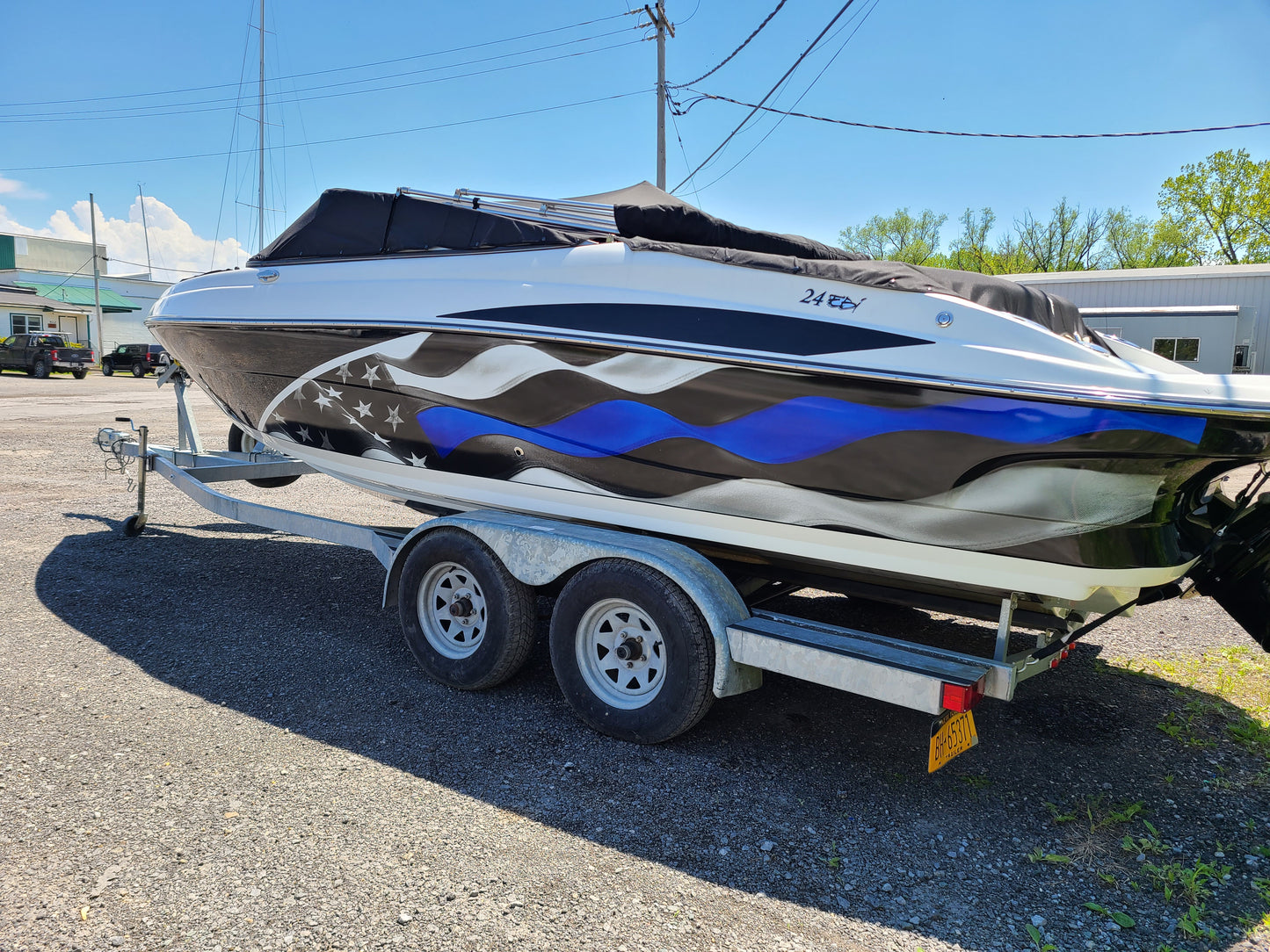 Boat wrap, boat hull wrap installed on power boat.  American flag wrap with blue stripe installed on boat.