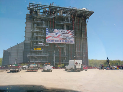 Large, jumbo sized mesh vinyl banner installed on building.  Oversized mesh banners allow air to pass through.